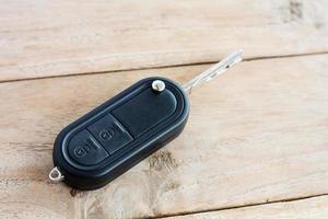 Car Key on old wood table background photo