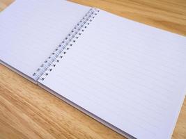 open notebook on wood table background photo