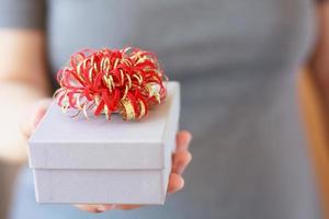 Woman holding gift box photo