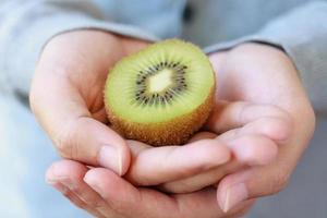 holding fresh kiwi fruit photo