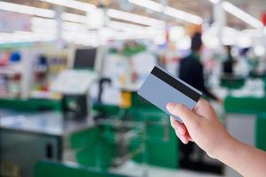 paying using credit card at supermarket checkout cashier photo