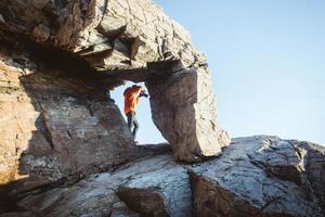 Photographer shooting from a rock formation photo