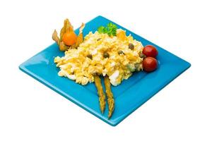 Scrambled eggs on white background photo