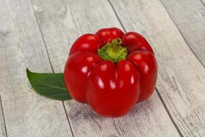 Ripe Red bell pepper over wooden photo