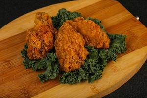 Hot fried crispy chicken wings photo