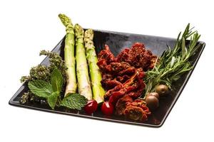 Dried tomato with asparagus and herbs photo