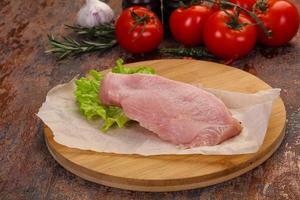 Raw Turkey steak served rosemary photo