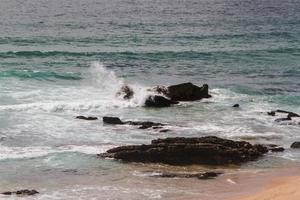 The waves fighting about deserted rocky coast of Atlantic ocean, Portugal photo