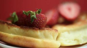 Belgian waffles with strawberries spinning on the table. video