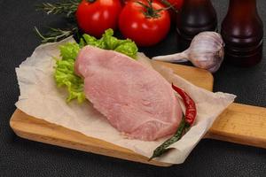 Raw Turkey steak served rosemary photo