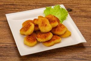 Fried chicken nuggets served salad leaves photo