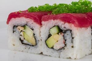 Maki Sushi - Roll made of Crab, avocado, cucumber inside. Fresh Tuna and tobico roe outside photo
