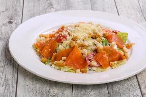 Caesar salad with salmon and parmesan photo