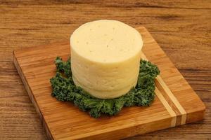 Yellow round dairy soft cheese photo