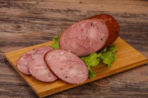 Smoked ham sausage with spices photo