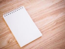 Notepad on the wooden desk table photo