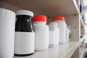 medicine bottles arranged on shelf at drugstore photo