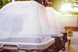 row of recycle waste bins close up photo