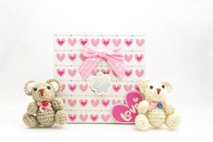 Valentines day scene Pink heart pattern gift box with a teddy bear on a white background photo