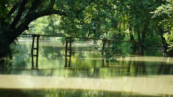 One old wooden bridge cross the river in the village of the China photo