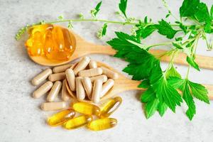 medicina alternativa cápsula orgánica a base de hierbas con vitamina e omega 3 aceite de pescado, mineral, medicamento con hojas de hierbas suplementos naturales para una vida sana y buena. foto