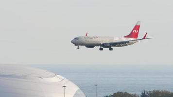 Boeing 737 airliner on final approach to Sochi flying over Sochi Olympic Park. video