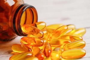 Fish oil or Cod liver oil gel in capsules with omega 3 vitamins, supplementary healthy food photo