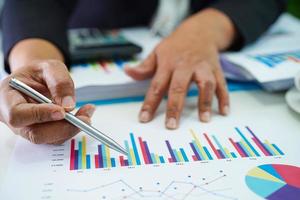 Businessman working and analysis with statistic graph in office. photo
