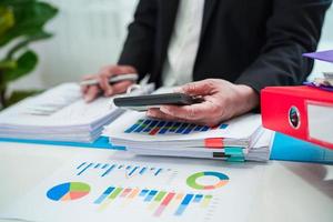 Businessman working and analysis with statistic graph in office. photo