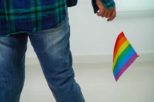 Asian woman with rainbow flag, LGBT symbol rights and gender equality, LGBT Pride Month in June. photo