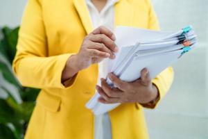 Businessman working and prepare paperwork report data to analysis information in file binder at office. photo