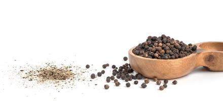 Black pepper seeds on white background. Food ingredients, spices photo