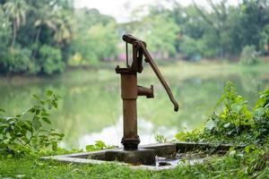 Hand operated water pump, rusted and forgotten photo