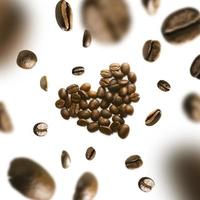 Coffee beans in the shape of a heart in flight on a white background photo