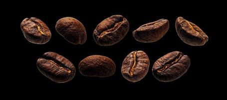 Coffee beans levitate on a black background photo