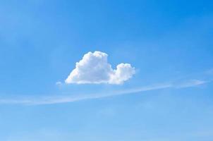 Single white cloud that look like snail in bright blue sky in summertime. photo