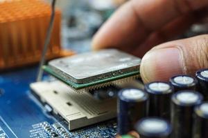 Hand assembled to inspect the electronic circuit board. photo