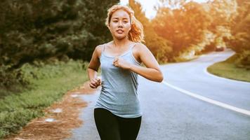 Women exercise on the street. Nature park. Asian women photo