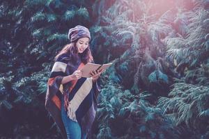 Young woman relax in the holiday. Travel nature and  write a note Happy to see the beauty of the pine leaf. Nature Study. photo