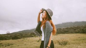 Asian women travel relax in the holiday. on a green pasture. photo