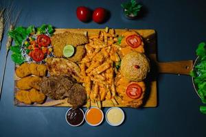 Grilled steak and lettuce, French fries on wooden plate photo