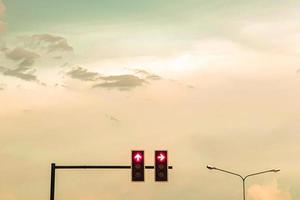 traffic light post with  sun set photo