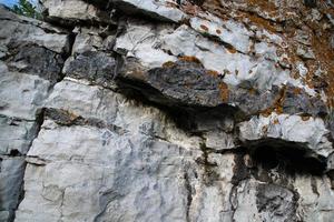 rock close-up with grass and blue sky photo