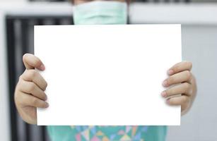 Woman standing posture holding blank white paper. photo