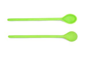 Green plastic spoon isolated on white background with clipping path. photo