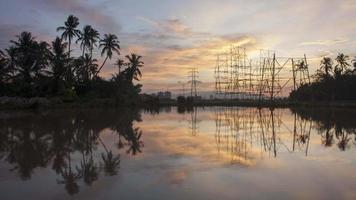 Wunderschöner Sonnenuntergang im Zeitraffer über der Architektur und den Kokospalmen