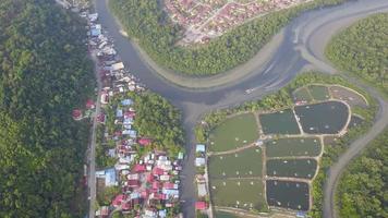 Aerial view two boat cross the Sungai Junjung river. video