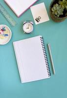 Blank notebook for writing on spirals on a blue background, flat lay, the end of motivation, business, building goals with negative industrial space and copy space photo