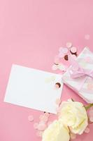 gift boxes and rose flowers on pink background. Happy Valentines day, Mothers day, birthday concept. Romantic flat lay composition. photo