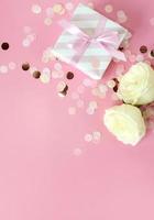 gift boxes and rose flowers on pink background. Happy Valentines day, Mothers day, birthday concept. Romantic flat lay composition. photo